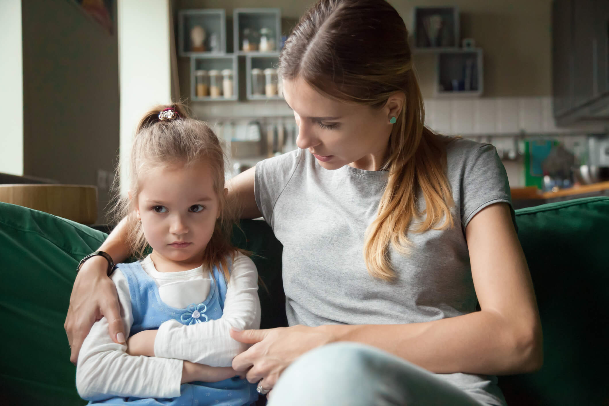 mother consoling upset daughter