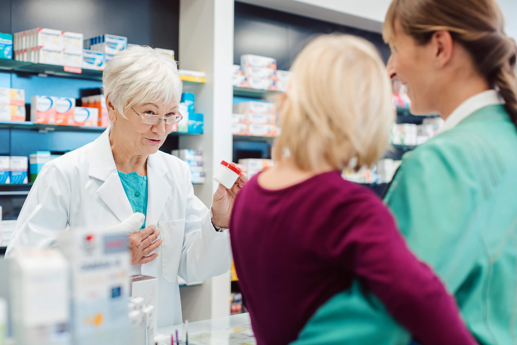 pharmacist talking to mom and kid