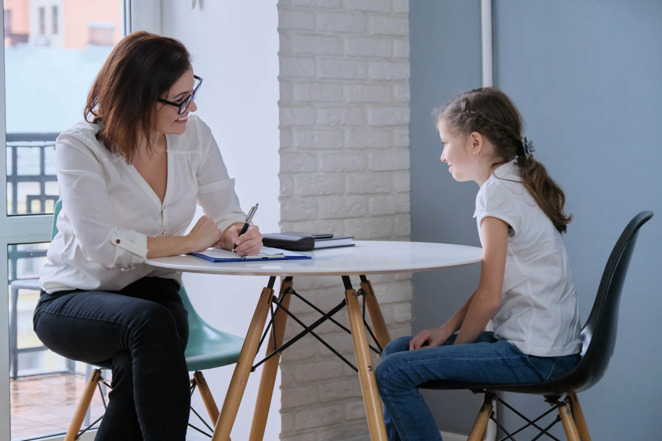 therapist talking to young girl